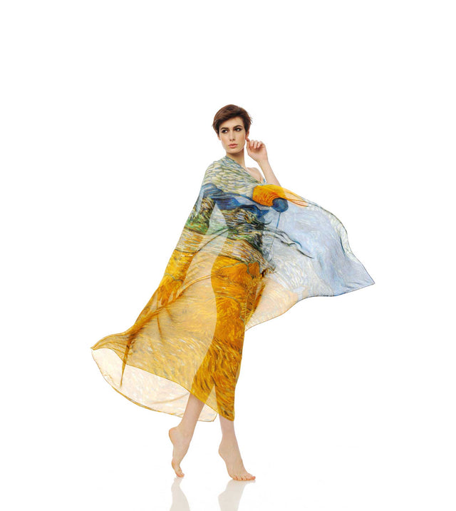Model wearing a flowing Vestilarte silk kaftan printed with a painted masterpiece